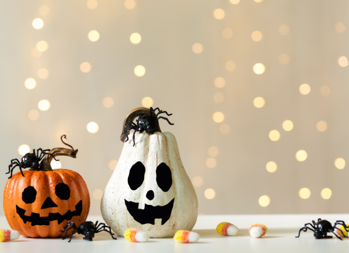 Two Halloween pumpkins with spooky faces.