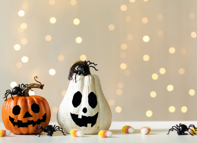 Two Halloween pumpkins with spooky faces. 