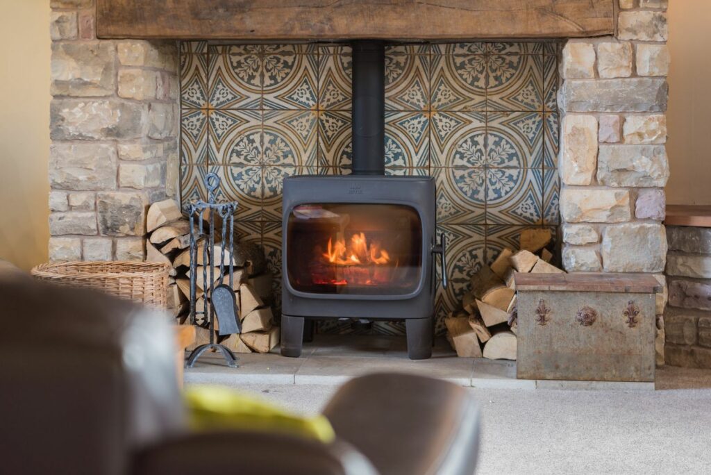 Fireplace space with a Moroccan tiles on the wall behind. 