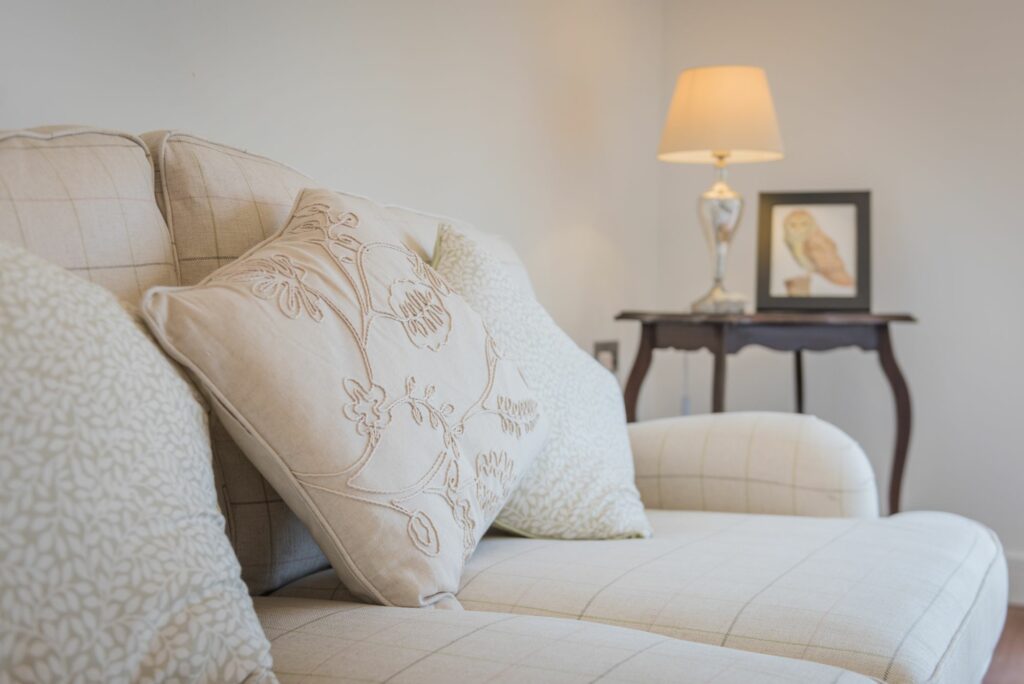 White sofa with cushions with different patterns. 