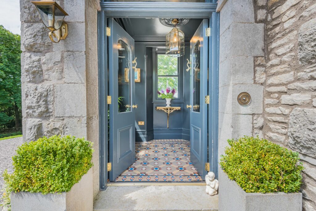 Open doorway of a house with stone siding 