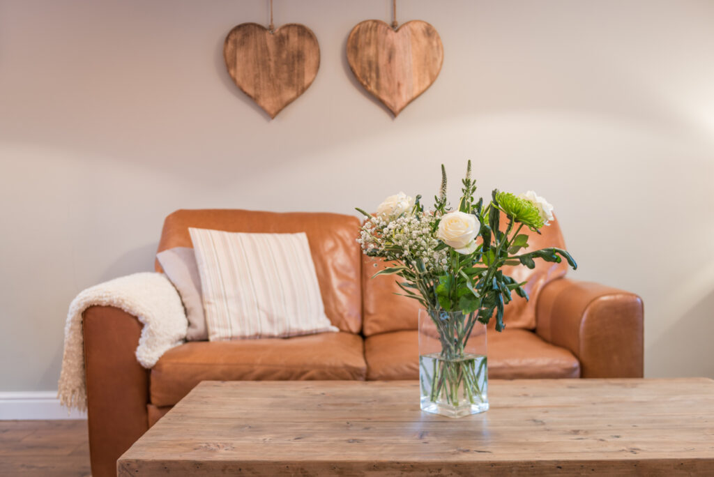 Vase with flowers on a wooden table 