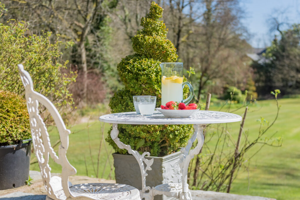 Cups with lemonade on outdoor coffee table, on a sunny day 