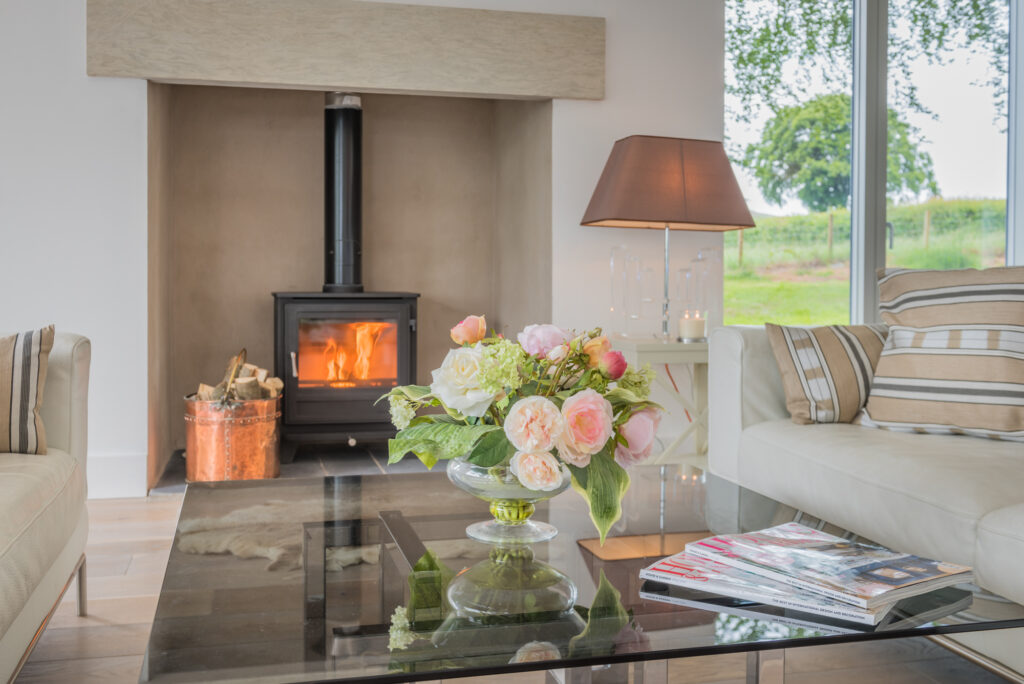 Modern living room with glass table and fireplace 