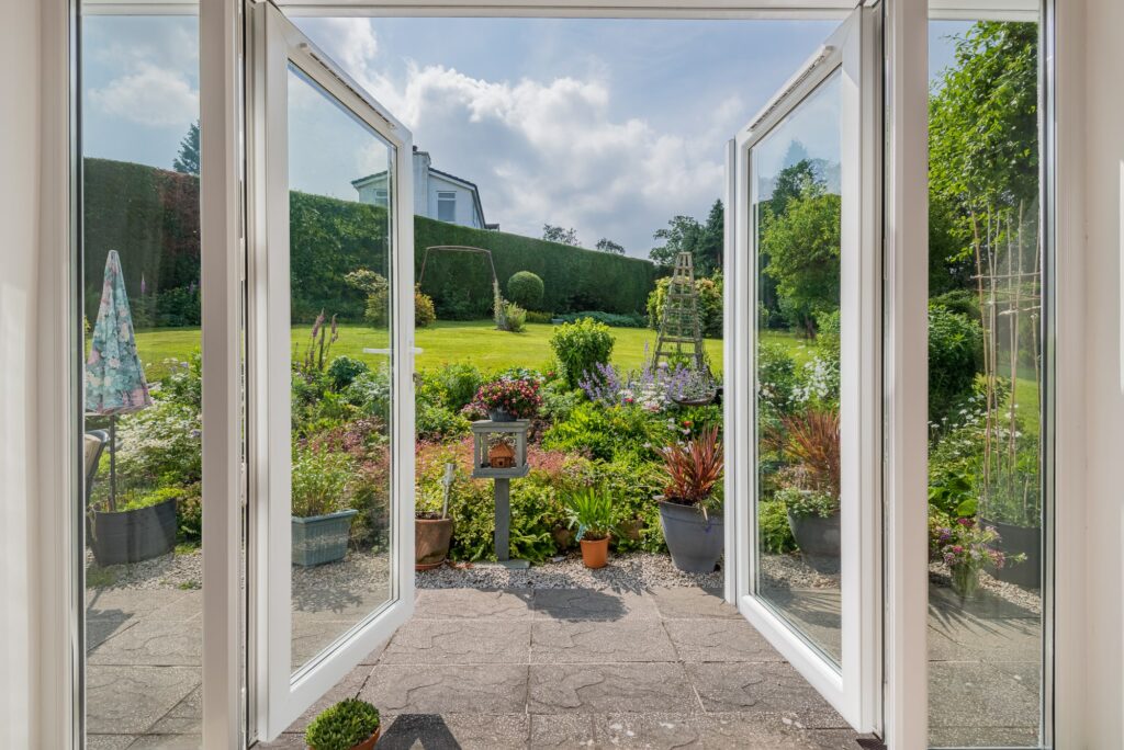 Wide open window with view to a beautiful garden 