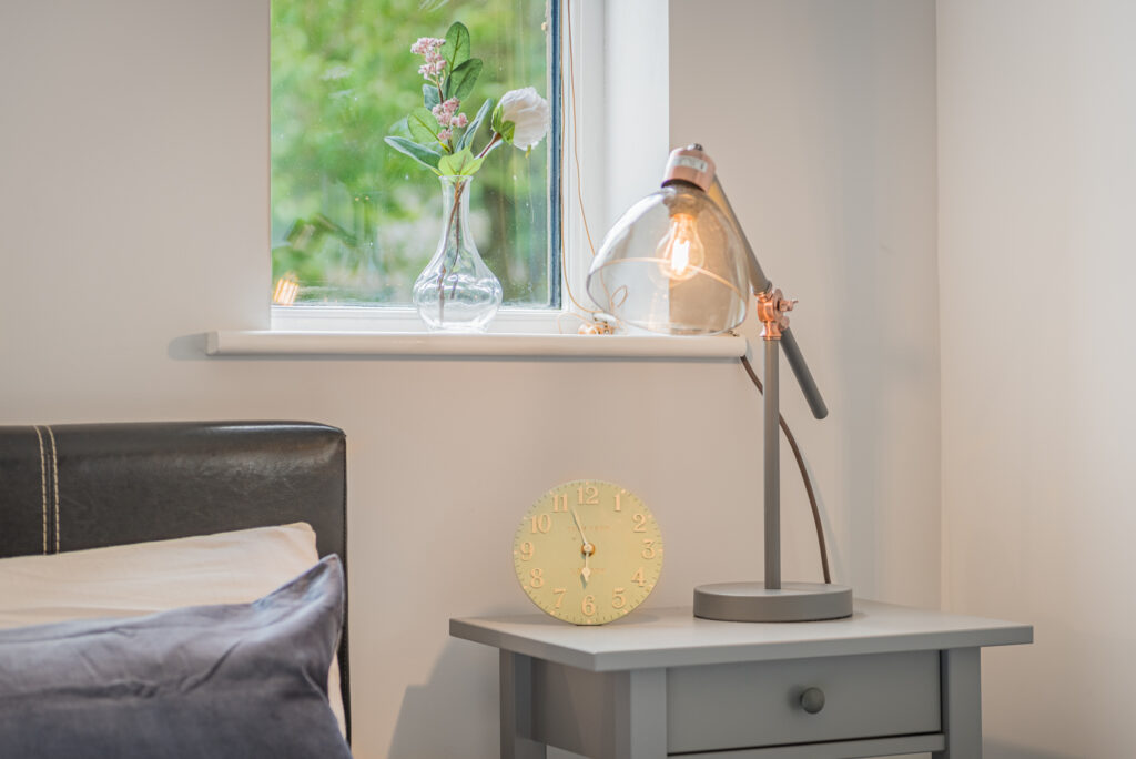 Bedroom corner with nightstand and window