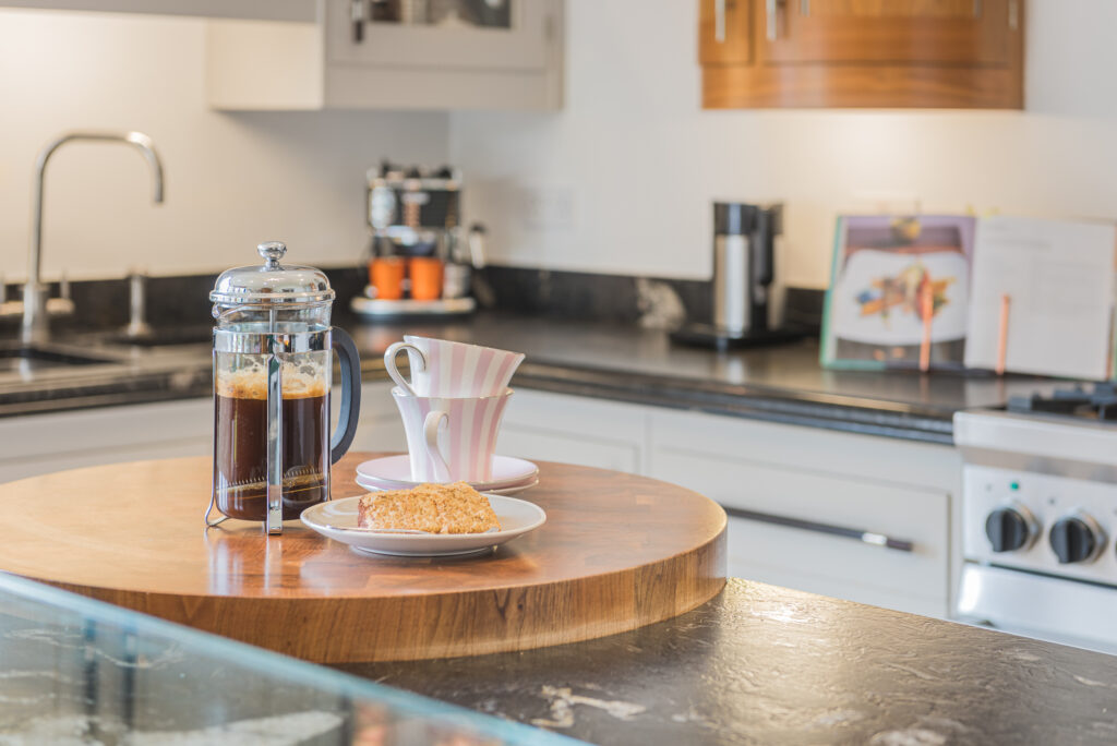 Kitchen interior, with coffee and mugs on top of a countertop 