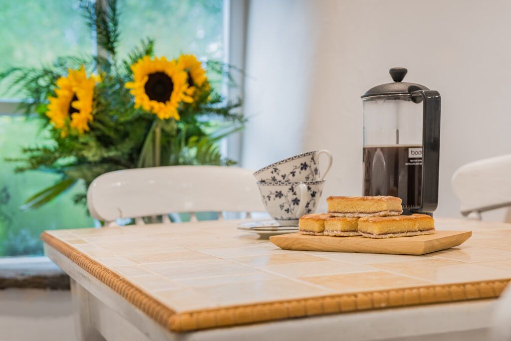 Kitchen table with breakfast and coffee on it. 