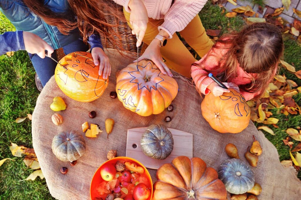 Parents and children making Halloween decorations