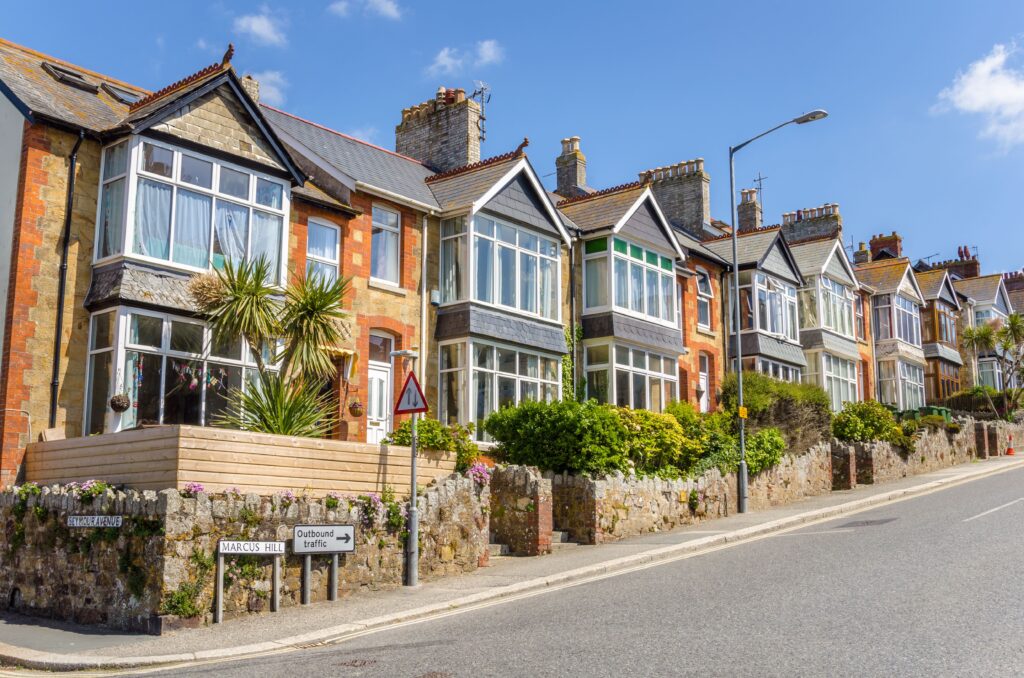 View of a street with residential buildings. 