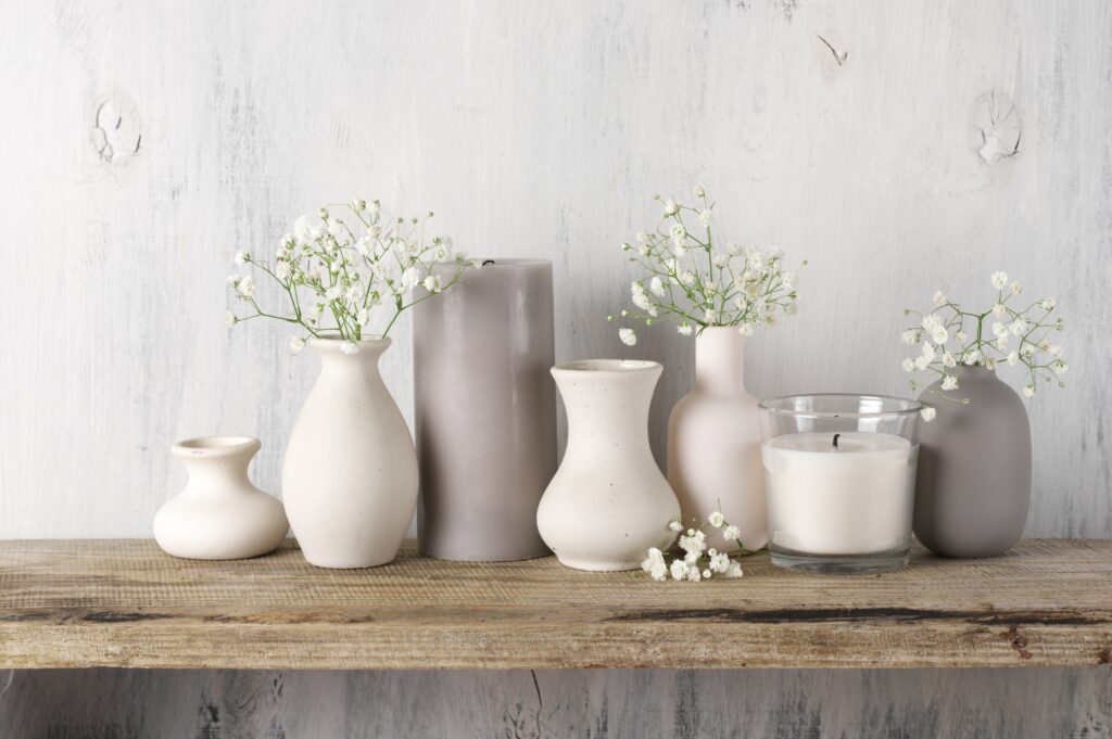 Vases with blowers on a shelve.