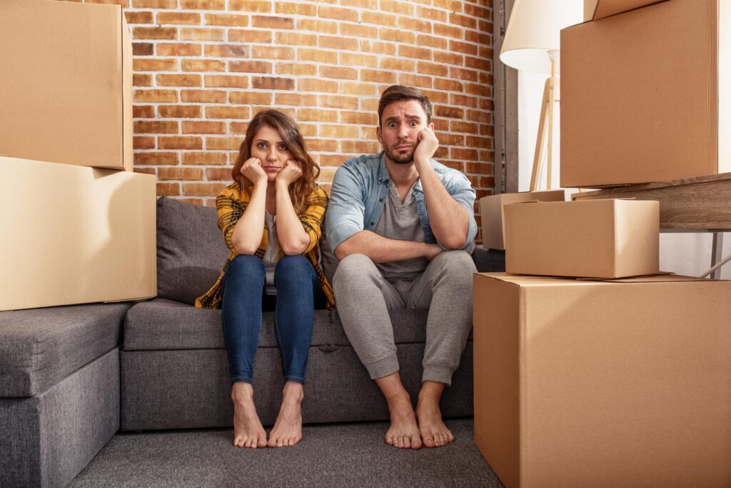 Concerned joint tenants surrounded by boxes.