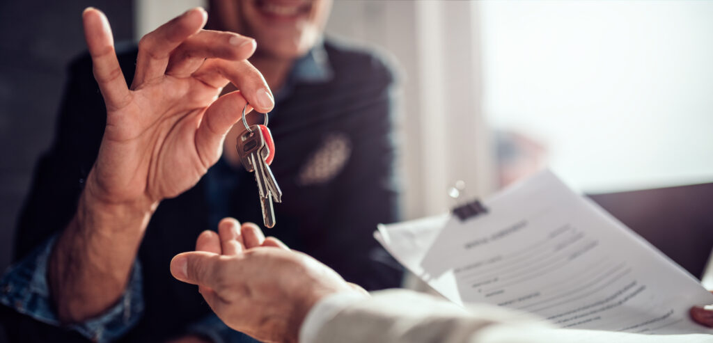 Letting agent giving keys to a new tenant. 