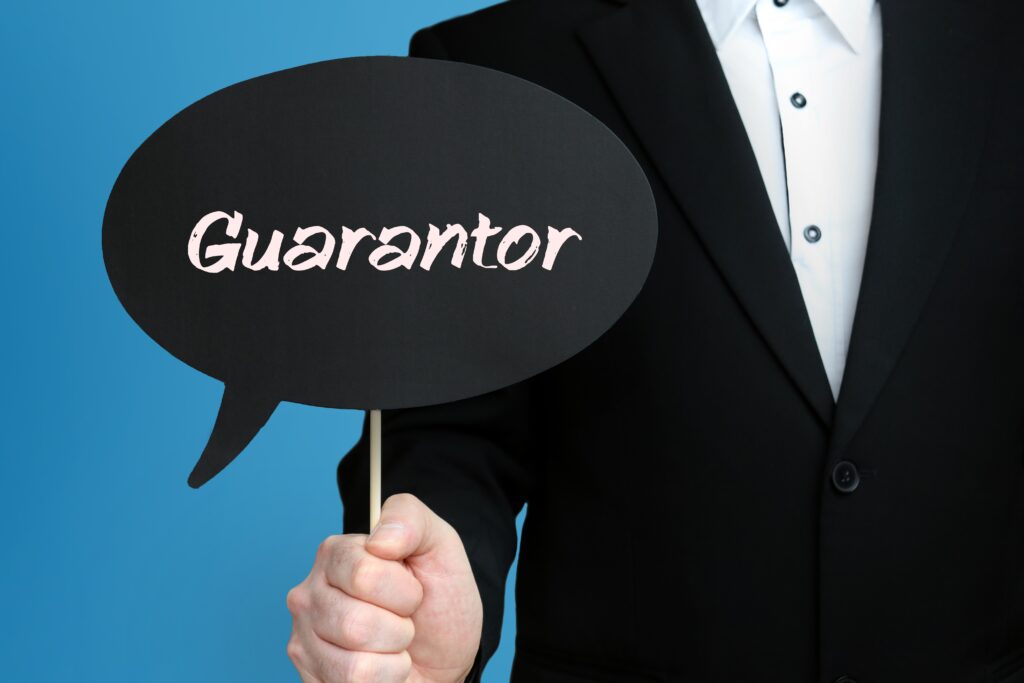 Home renting guarantor holding a sign.