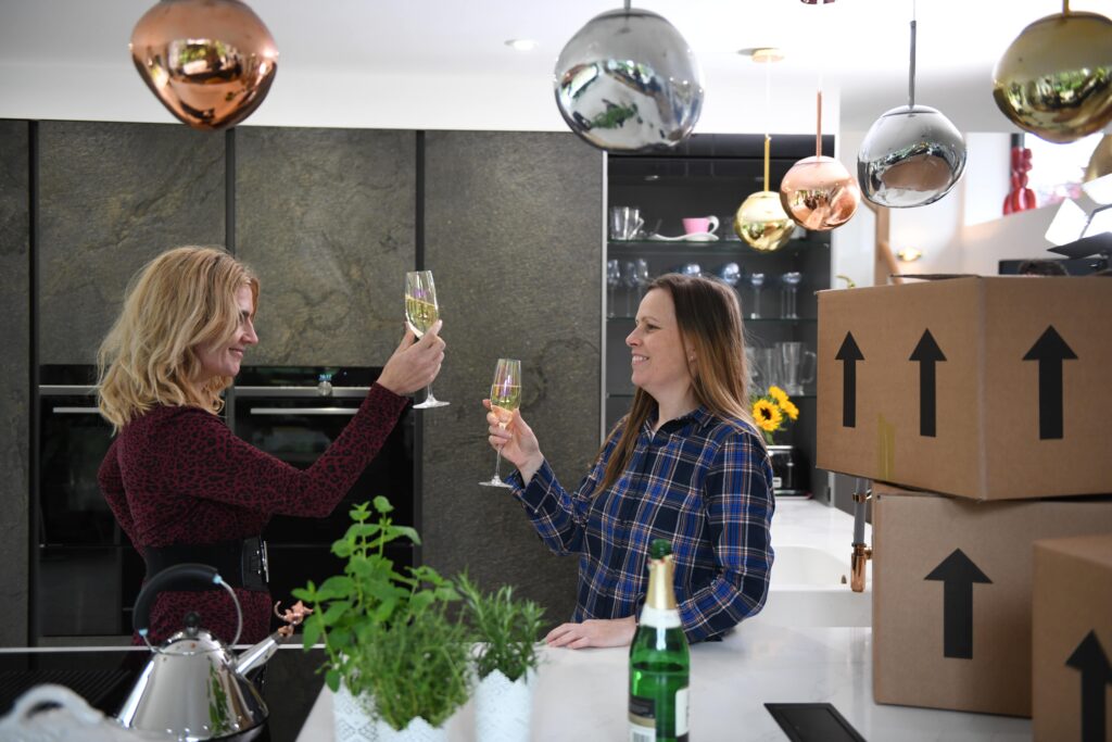 Two women toasting for their new house.