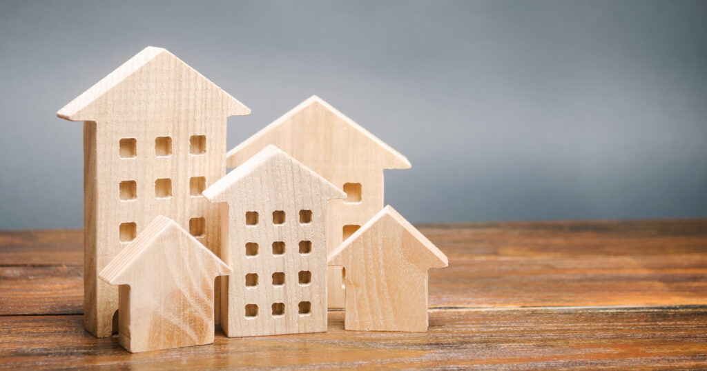 Wooden house models on a table.