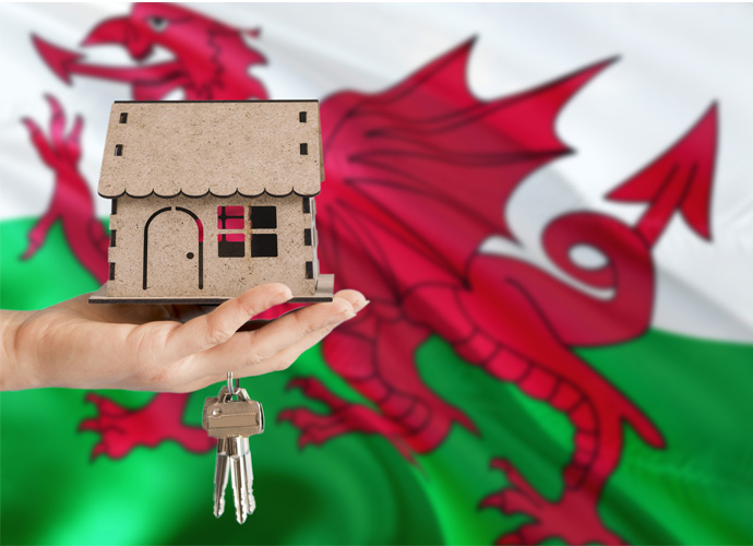 House and keys in front of the Welsh flag.