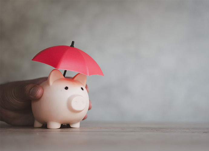 Piggy bank with red umbrella.