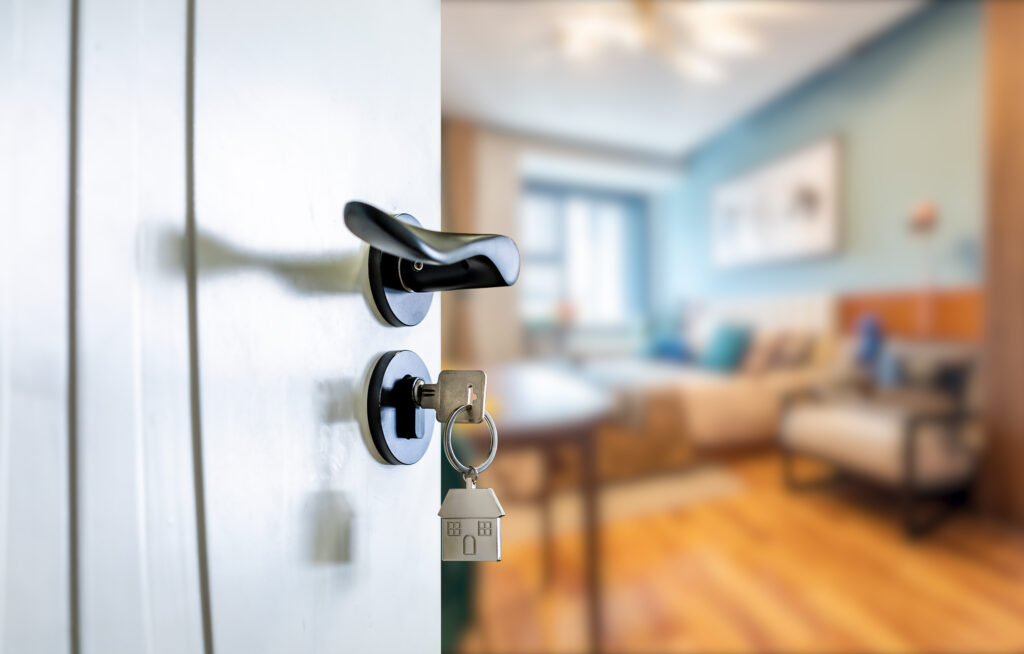 An open door to a rented house, with keys on it.