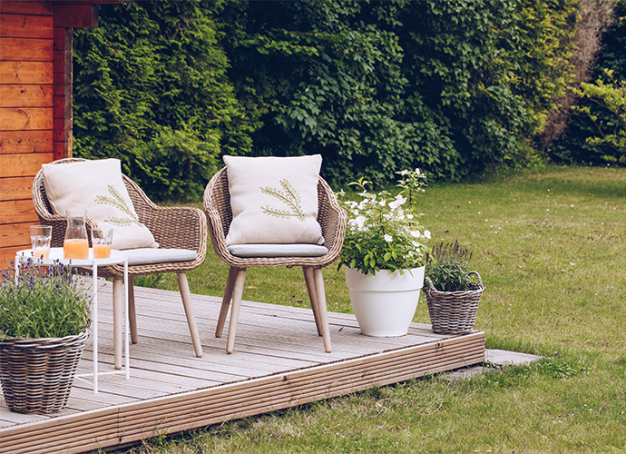 Patio deck with two chairs and coffee table.