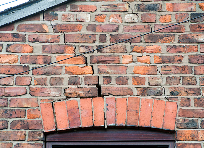 Brick wall with cracks, caused by subsidence.