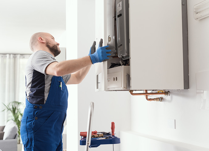 Expert engineer inspecting a boiler at a residential location.