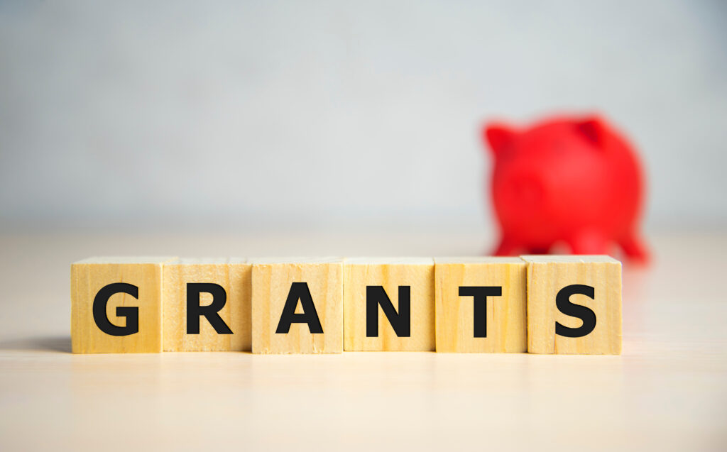 Wooden cubes with letters, forming the word "Grants" 