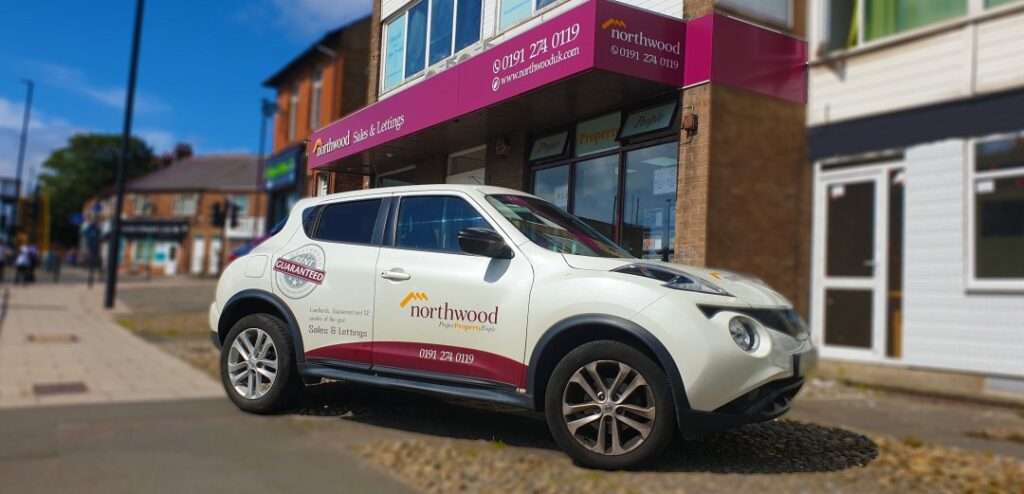 Exterior view of Northwood estate agents office in Newcastle with company car