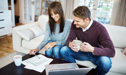 Couple reviewing property valuation figures at home ahead of selling in Southport