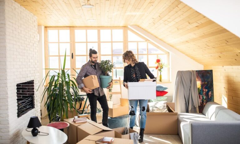 Landlords unpacking boxes and preparing a rental property for winter maintenance in a UK home