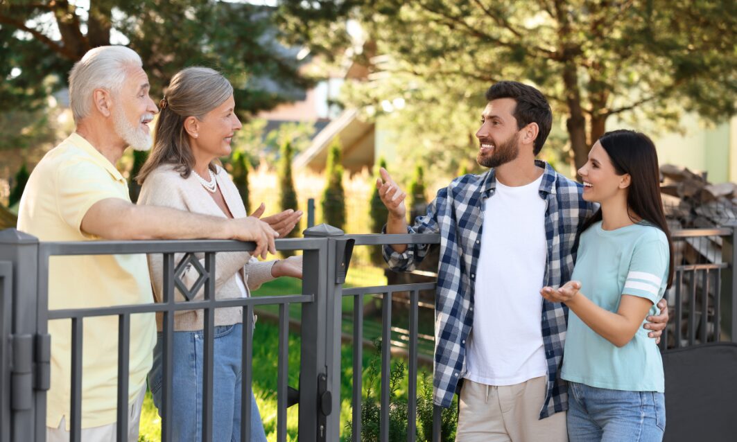 Family talking to neighbours outside a home in a Southport neighbourhood