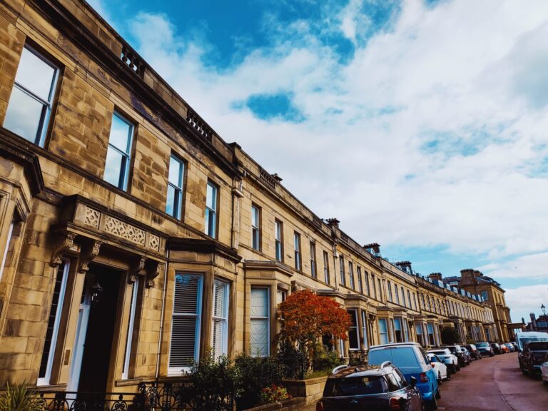 Traditional sandstone terrace houses on a residential street in Scotland
