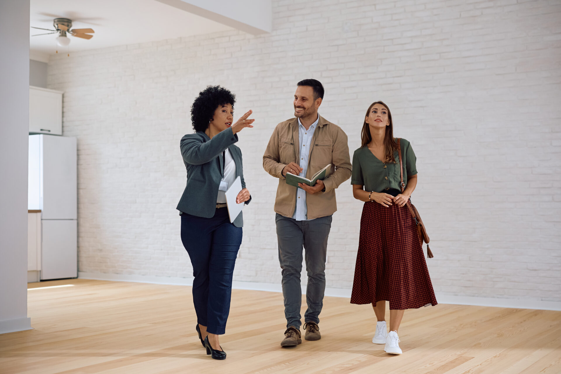 Letting agent showing a rental property to a couple during a viewing in Southport