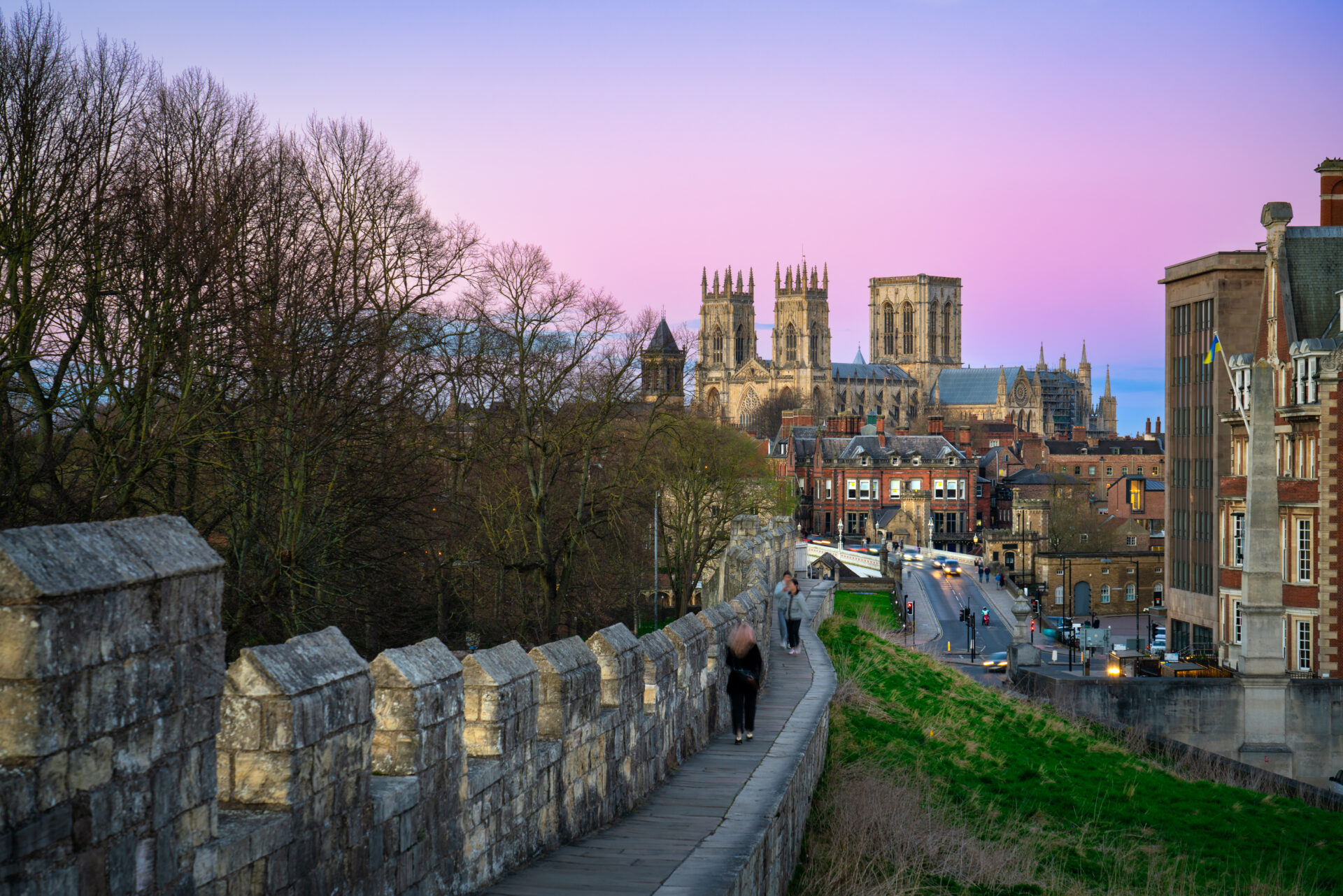 View of York Minster and city skyline from historic city walls at sunset