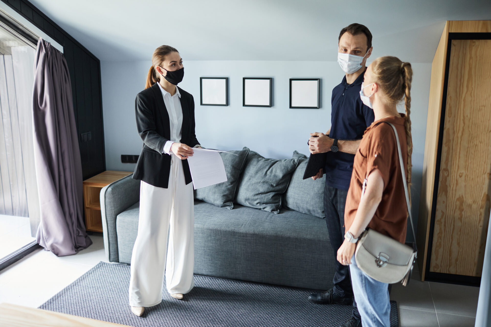 Letting agent showing rental agreement to prospective tenants in a modern Tang Hall York property