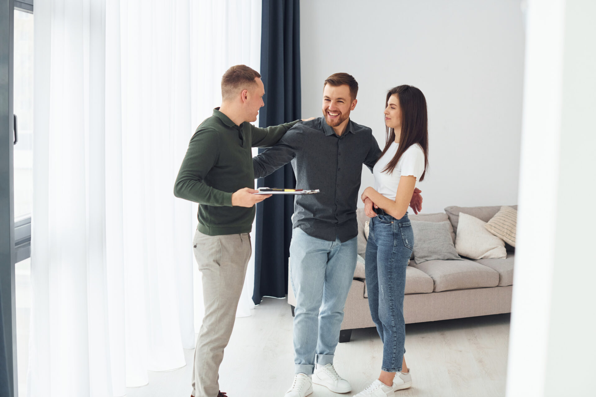 Estate agent showing apartment to young couple during property viewing in Liverpool Baltic Triangle