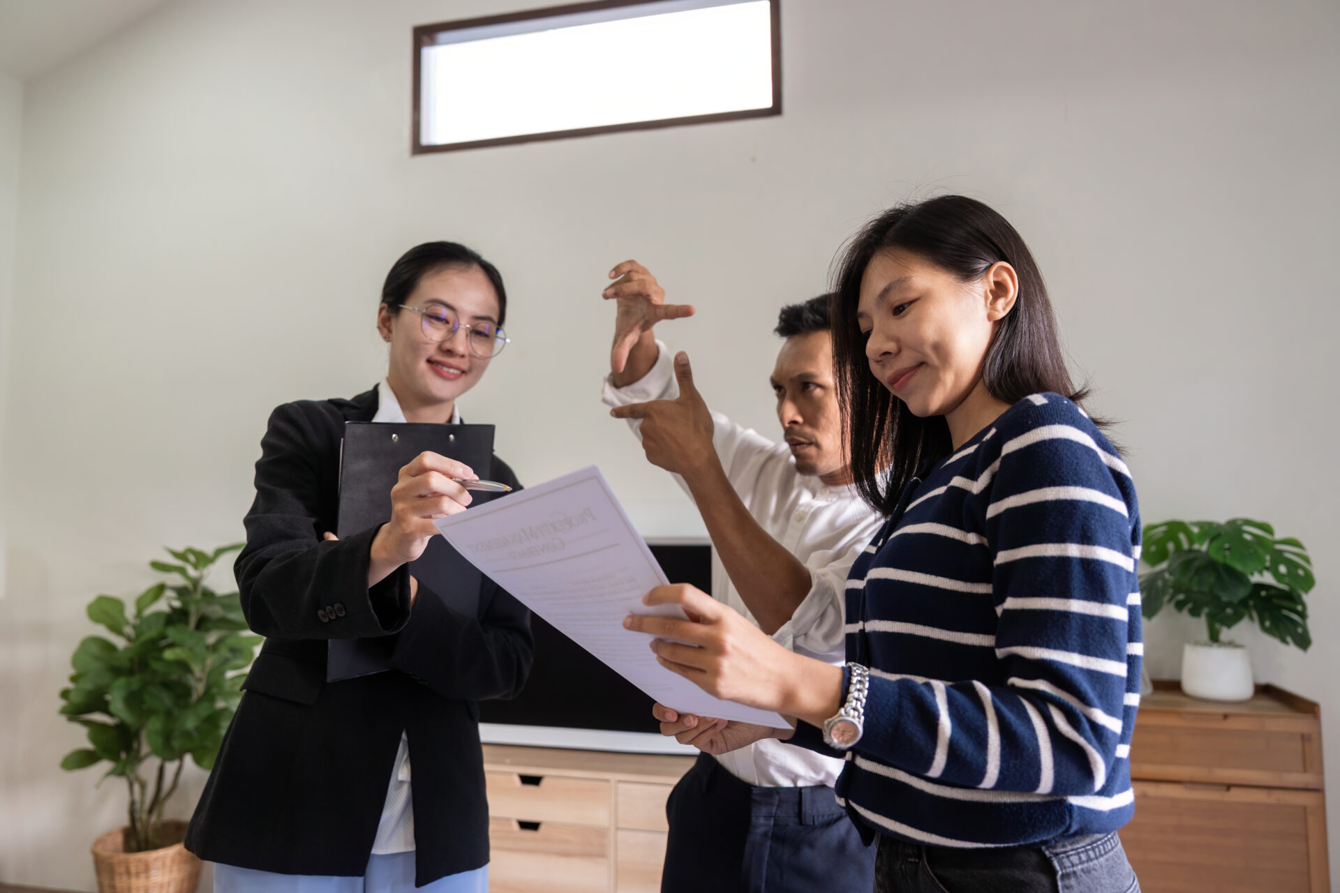 Letting agent explaining rental agreement to prospective tenants during a property viewing in Northampton