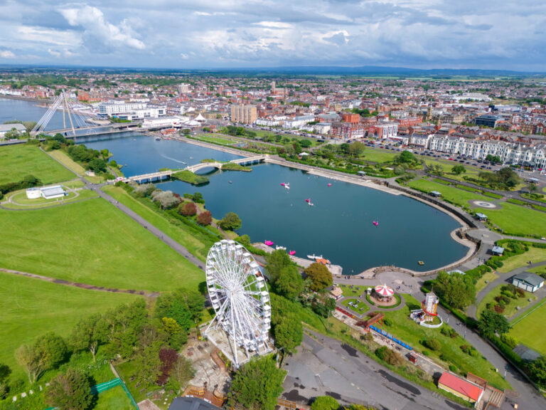 Drone view of Southport Marine Lake, waterfront promenade and town centre in Merseyside
