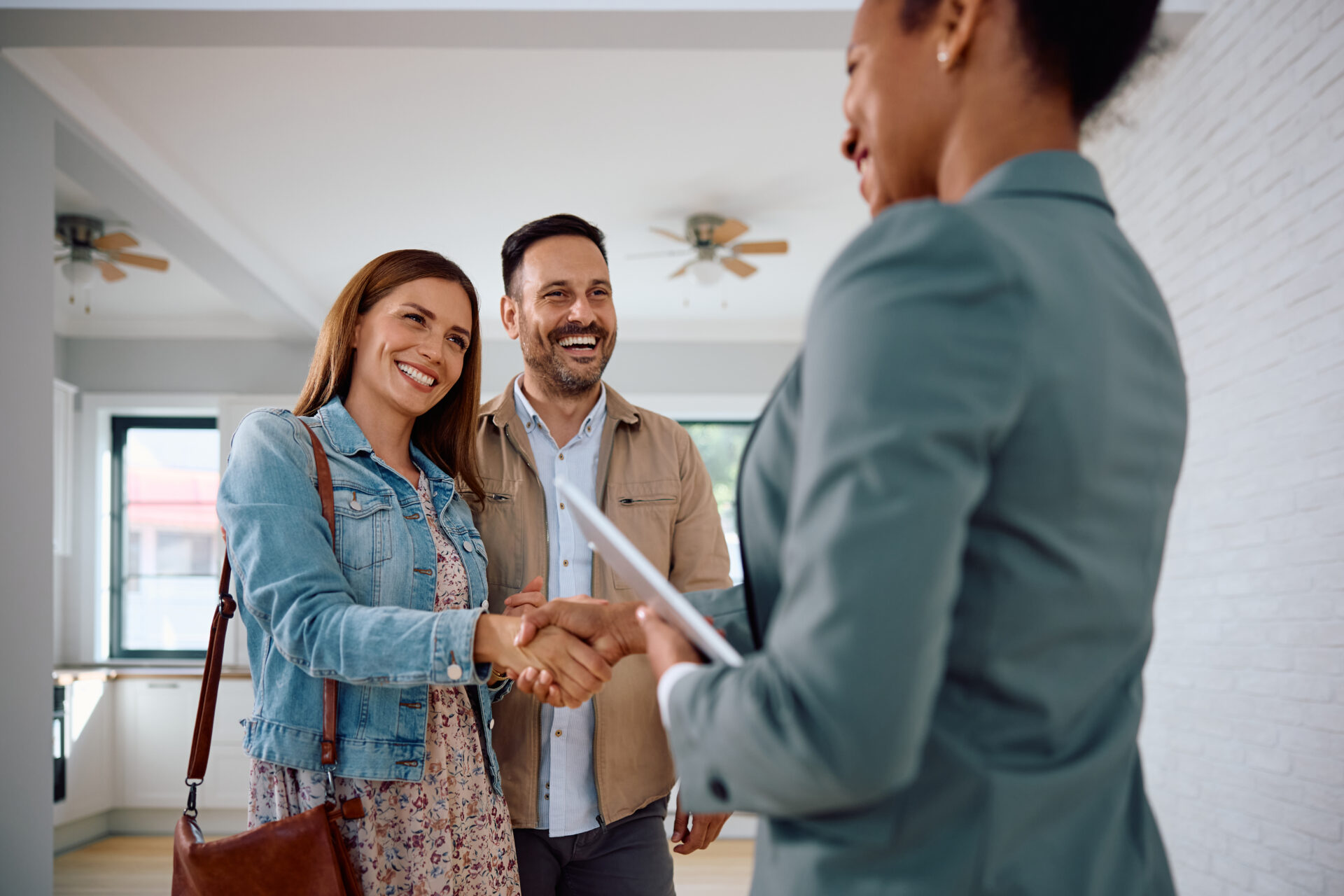 First-time landlords shaking hands with a letting agent during a rental property meeting in Warminster.