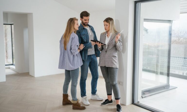 Letting agent explaining HMO rental property details to prospective tenants in Portsmouth.