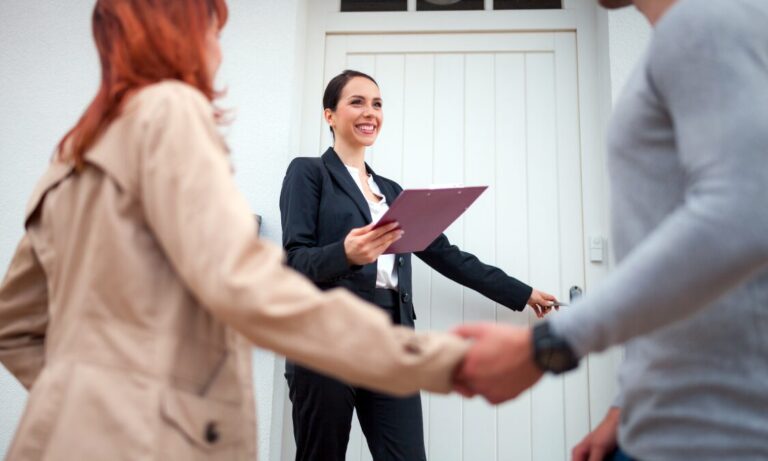 Estate agent welcoming a couple to a property viewing, representing Portsmouth house prices and seller demand in PO4 and PO5.
