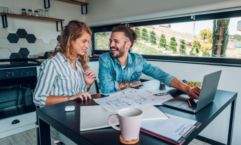 Couple reviewing property plans and rental information at home