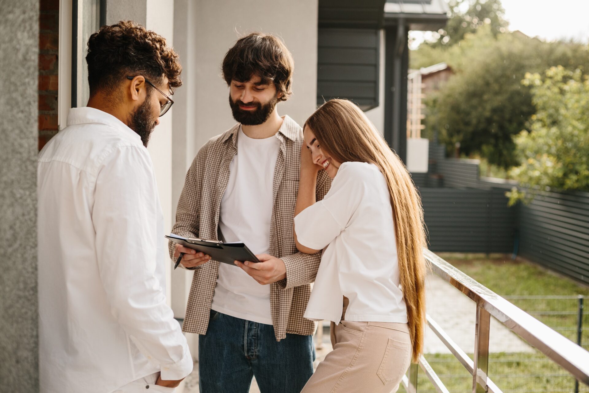 Estate agent discussing property details with a couple outside a home in Bristol's BS34 area.