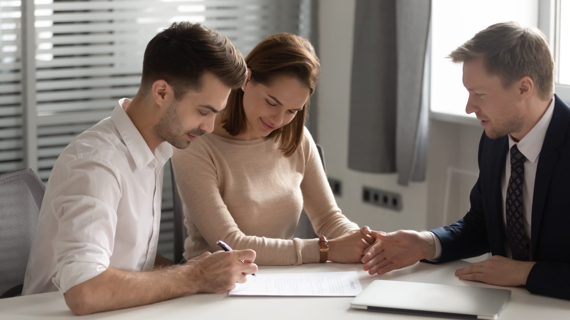 Prospective landlords meeting with a letting agent to sign rental paperwork in Liverpool.