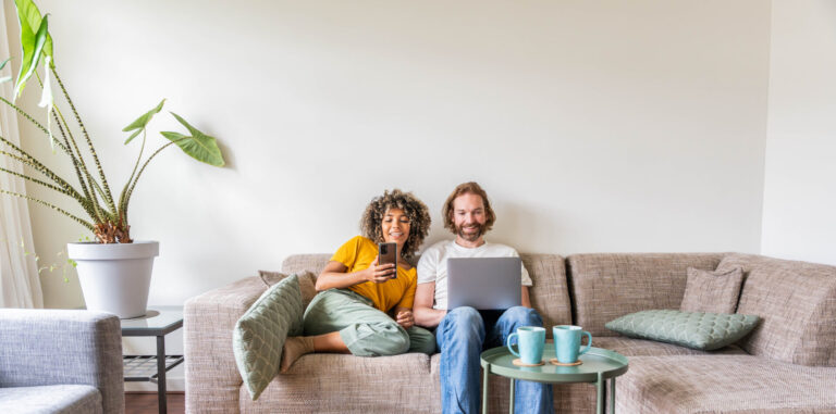 A couple relaxing at home while browsing property information online in Acomb, York.