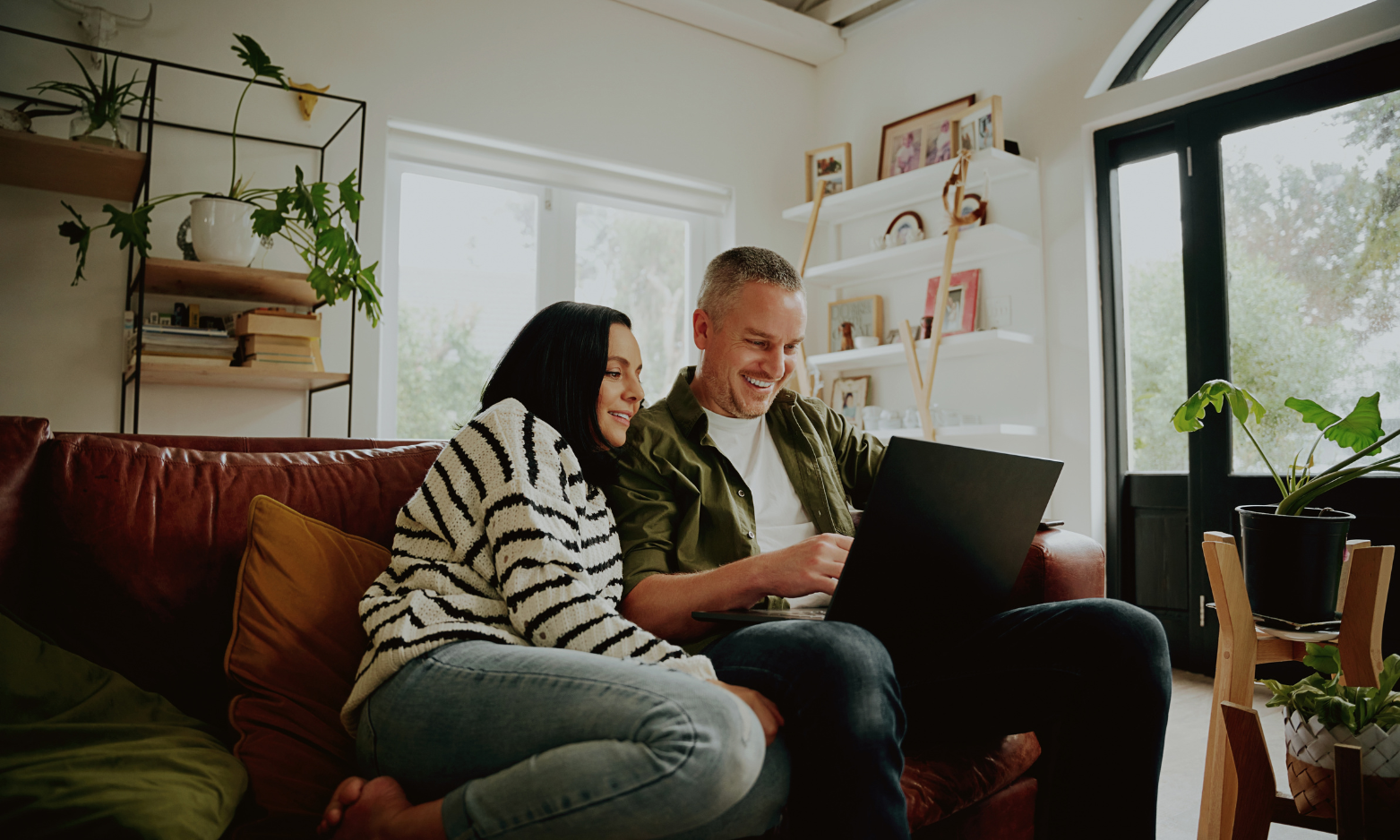 Couple researching their property sale online from their home