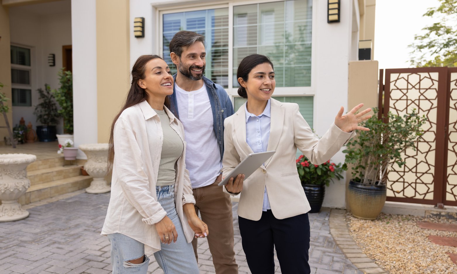 Homeowners discussing a property valuation outside a house in Hessle