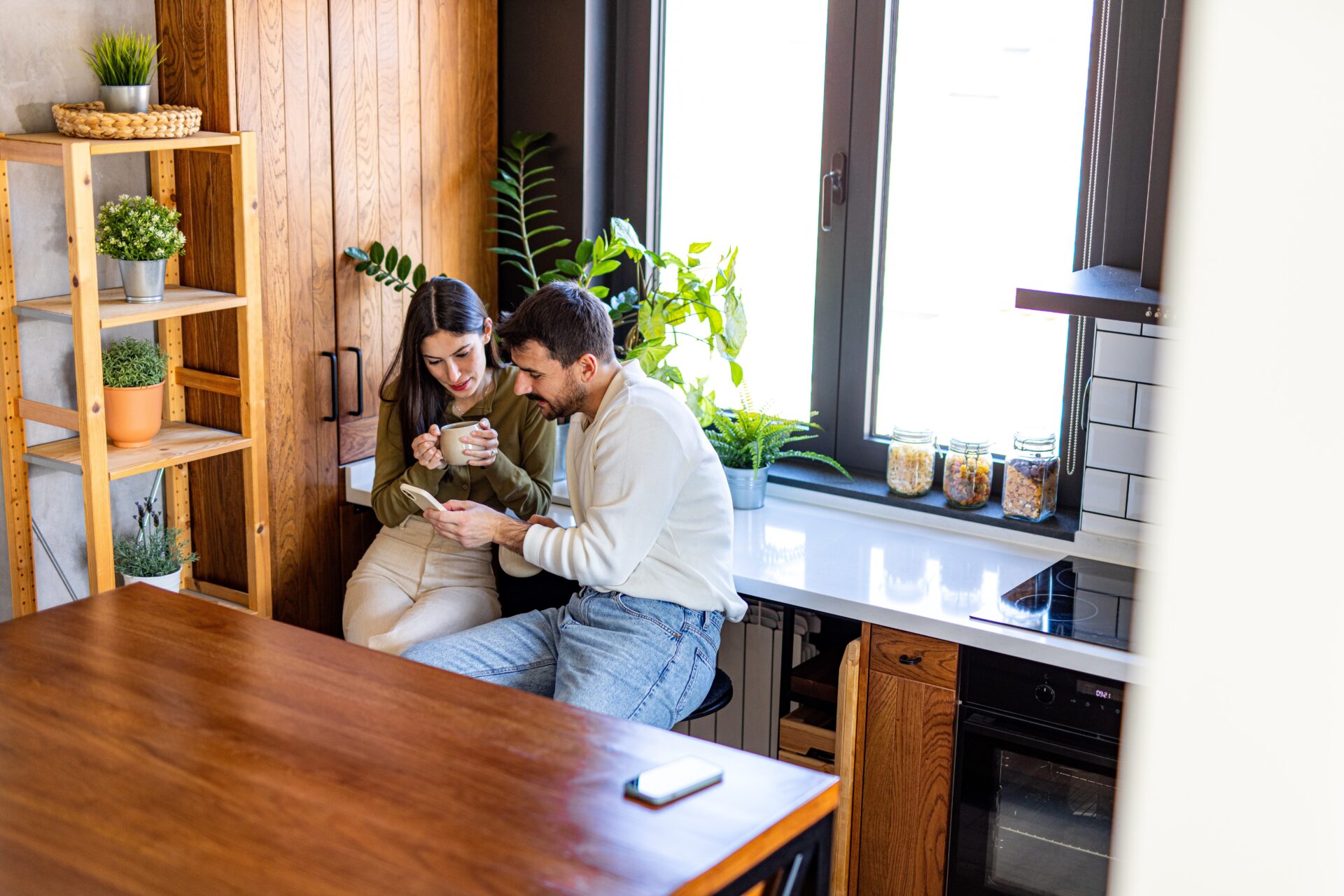 Couple sitting together in a bright wooden kitchen, reflecting home life in Huntington YO32, York