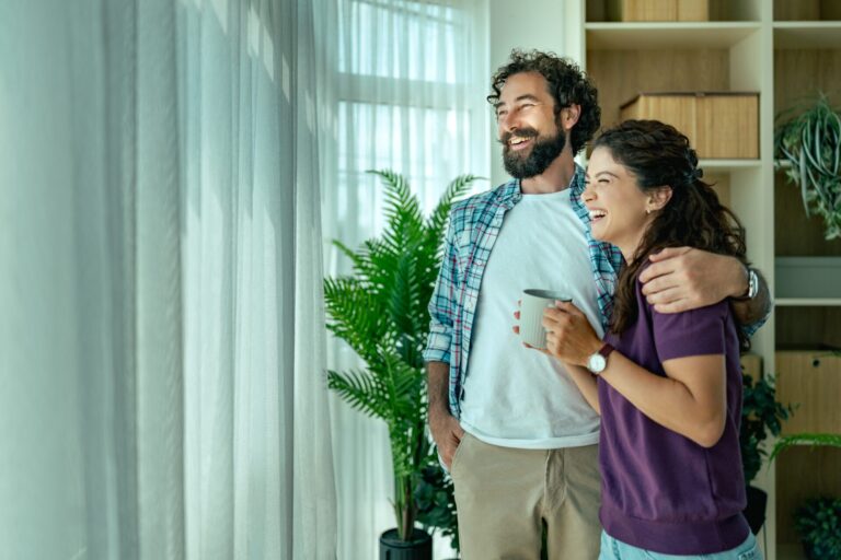 Happy young couple celebrating buying their first home in Portsmouth