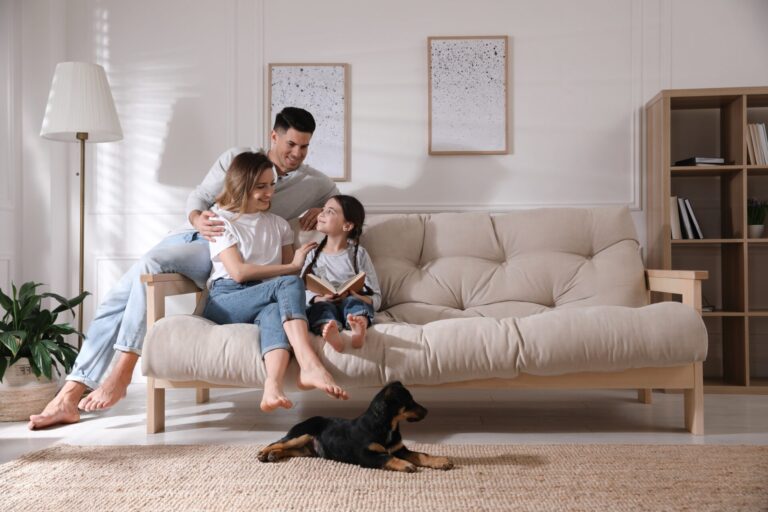 Family relaxing together on the sofa of a rented home in The Groves, York YO31